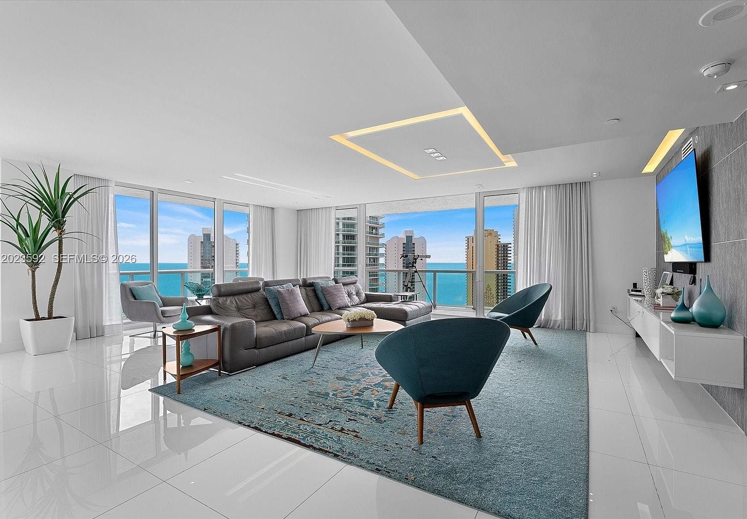 A second framing of the great room showing the relationship between seating, ceiling light, and the Atlantic horizon line.